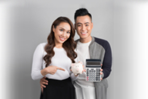 young couple thinking of debt vs savings
